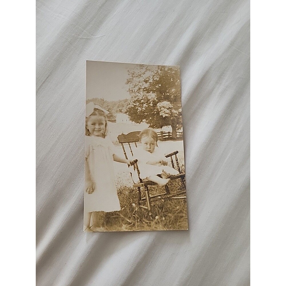 RPPC Child Baby Rocking Chair Girl With Bow Barn Tree Postcard Vtg